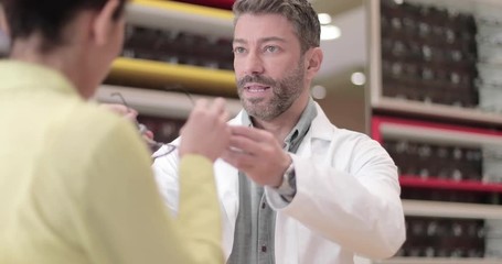 Optician suggesting frames to customer