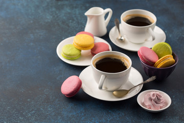 Two cups of coffee and sweets on table
