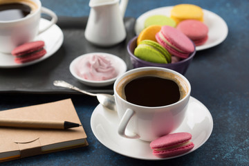 Two cups of coffee and sweets on table
