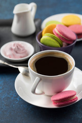 Cup of coffee and sweets on table