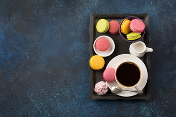 Cup of coffee and sweets on table