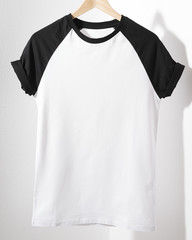 Front view of American Hipsters retro classic tshirt clothes. Blank template of vintage t-shirt hanging on a hanger on white background. Closeup