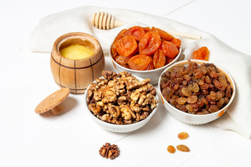 Set of dried berries, fruits and nuts lying in a plate(walnuts,pumpkin, cherry, apricot, Apple, dates)