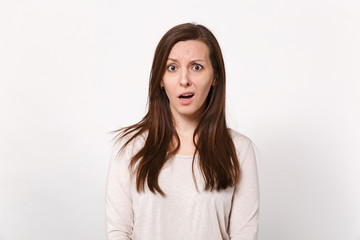 Obraz premium Portrait of perplexed bewildered puzzled young woman in light clothes standing and looking camera isolated on white background in studio. People sincere emotions lifestyle concept. Mock up copy space.