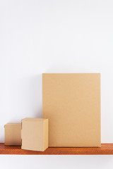 cardboard box on wooden shelf