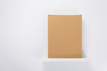 cardboard box on wooden shelf