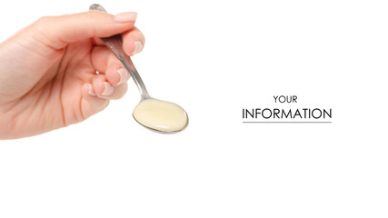 Condensed milk in spoon in hand pattern. Isolation on a white background pattern