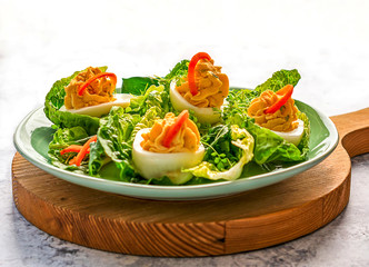 Festive deviled eggs on green salad leaves