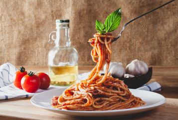 Spaghetti in a dish on a wooden background