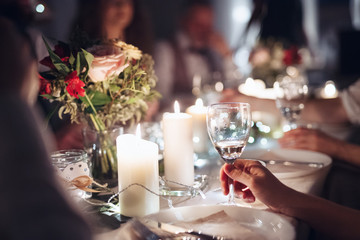 Midsection of family sitting at a table on a indoor birthday party, holding glasses.