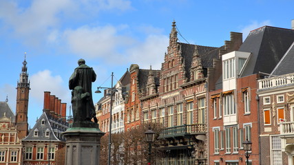 Fototapeta na wymiar The Grote Markt Square with ornate and colorful traditional buildings in Haarlem, Netherlands, and with the statue of Laurens Janszoon Coster (erected in 1722) in the foreground