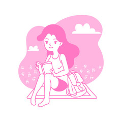 Young woman reads the book on meadow