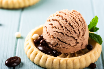 Homemade coffee and vanilla ice creamwith chocolate candies on blue background. Healthy summer food concept.