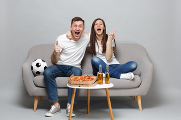 Happy couple woman man football fans cheer up support favorite team expressive gesticulating hands...