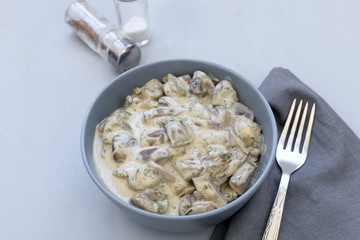 Curry mushrooms with creamy sauce on gray wooden background. Healthy eating or vegetarian concept. Copy space.
