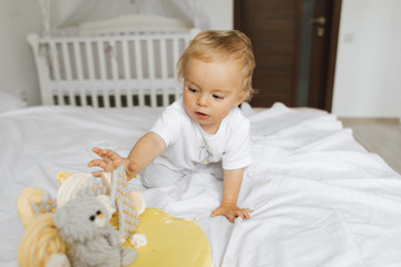 Fototapeta premium The child stretches to sweets from the cake