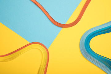 top view of curved multicolored lines on blue and yellow background