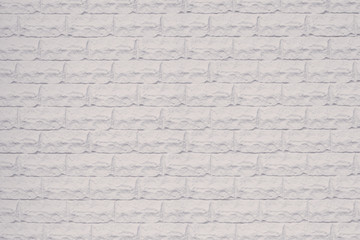 Decorative white stone wall. White brick wall texture. Empty space. Pattern of white brick wall. White wall of tile texture background.  