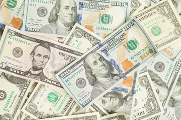 Fototapeta na wymiar US dollar money cash background. Heap of American Dollars 100, 1 and 5 banknote gift profit concept