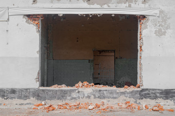 Old abandoned house with broken wall