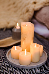 Fototapeta na wymiar Burning candles on table indoors. Interior decor element