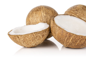 Group of two whole two halves of fresh bio coconut isolated on white background