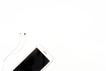 white phone and headphones on white background