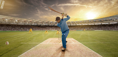Young sportsman strikes the ball while batting in the cricket field	