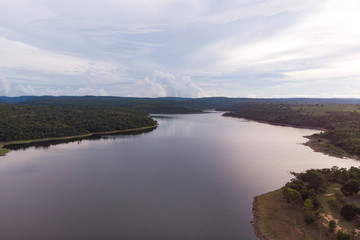 Fototapeta na wymiar Drone shot Aerial view landscape scenic of big river reservoir with nature forest and mountains in tropical land