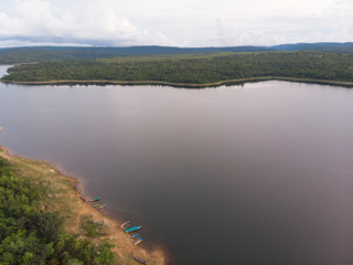 Drone shot Aerial view landscape scenic of big river reservoir with nature forest and mountains in tropical land
