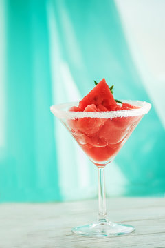 Slices of watermelon on a bright table and in a glass goblet, summer mood.