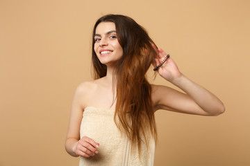 Close up brunette half naked woman 20s with perfect skin, nude make up isolated on beige pastel...