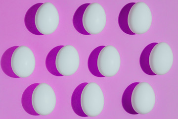White chicken eggs  with empty space, on a pink background. Abstract image