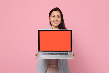 Portrait of smiling young woman in striped jacket holding laptop pc computer with blank empty...