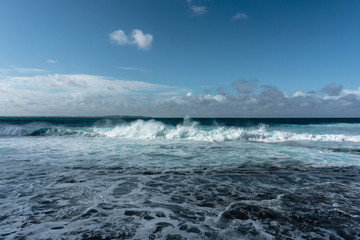 waves in the ocean and blue sky