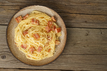 Carbonara pasta. Spaghetti with bacon, egg, parmesan cheese. Traditional italian cuisine. Top view, copy space