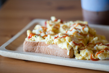 Scrambled eggs on toasted bread with ketchup