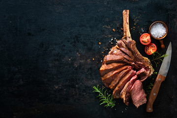 Grilled dry aged tomahawk steak sliced as close-up