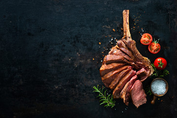 Fototapeta Grilled dry aged tomahawk steak sliced as close-up obraz