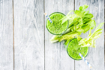 Healthy vegan food and drink. Diet green cucumber and celery smoothie cocktail, on a wooden background,