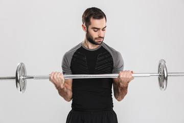 Young sports fitness man isolate over white wall background make exercises with barbell.