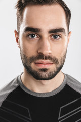 Obraz premium Handsome young sports fitness man posing isolate over white wall background.