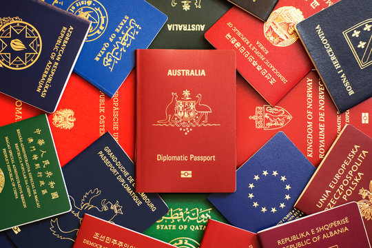Australia's red biometric diplomatic passport among multicolored passports of many countries of the world