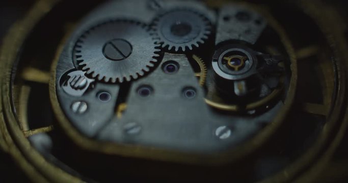 Old clock mechanical part working slowly mooving white lightning from right side static angle view ProRes 4444