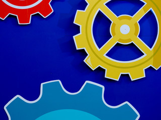 Large cog wheels engine gear wheels blue background, industrial background