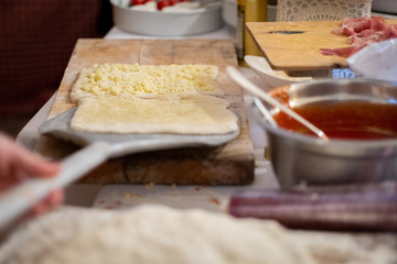 The pizza maker is baking the white pizza