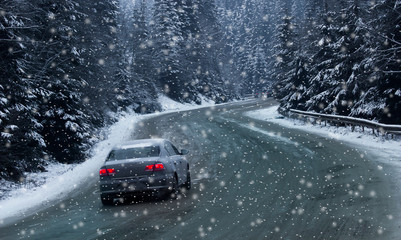 scenic veiw car on road with snow covered landscape while snowing in winter season
