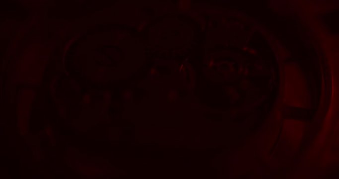 Old clock mechanical part working mooving red lightning from right side camera goes backward angle view ProRes 4444