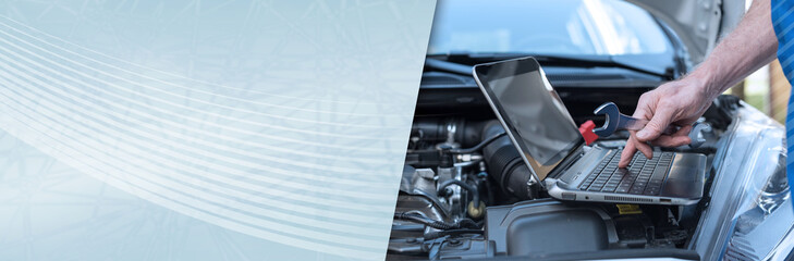 Mechanic using laptop for checking car engine. panoramic banner