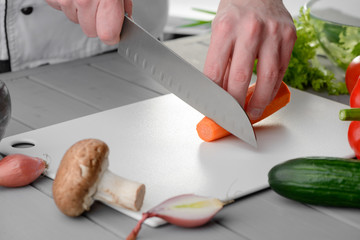 Chef cook cutting a carrot